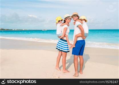 Young family on the beach. Photo of happy family having fun on the beach. Summer Lifestyle