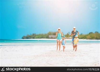Young family on the beach. Summer vacation. Photo of happy family having fun on the beach. Summer Lifestyle