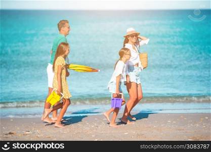 Young family on the beach vacation. Summer Lifestyle. Photo of happy family having fun on the beach. Summer Lifestyle