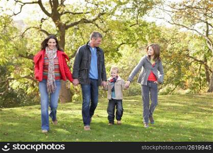 Young Family Outdoors Walking Through Park