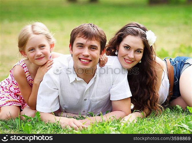 Young Family Outdoors Walking Through Park in summer