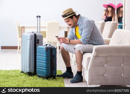 Young family packing for vacation travel