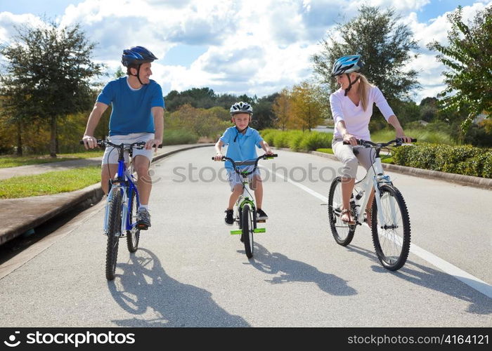 Young Family Parents and Boy Son Cycling