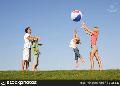 Young family, parents with children, playing in a field