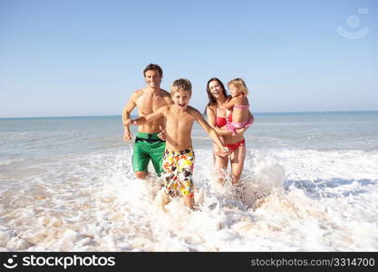 Young family play on beach