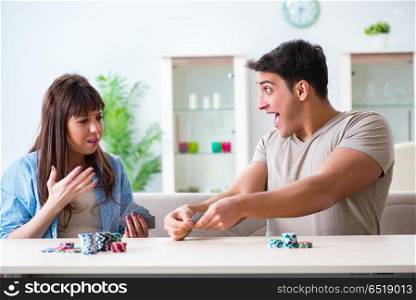 Young family playing cards at home