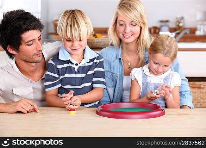 Young family playing dice