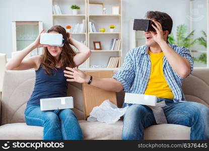 Young family playing games with virtual reality glasses