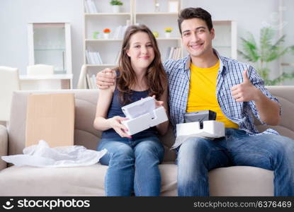 Young family playing games with virtual reality glasses