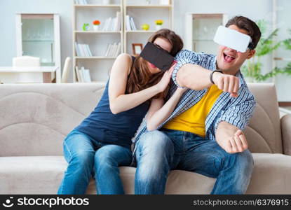 Young family playing games with virtual reality glasses