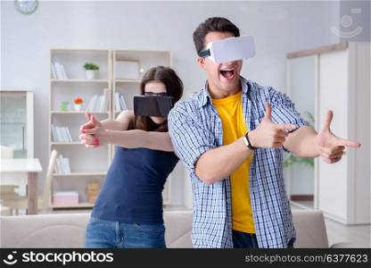 Young family playing games with virtual reality glasses