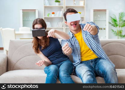 Young family playing games with virtual reality glasses