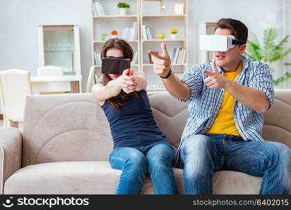 Young family playing games with virtual reality glasses