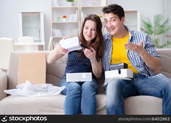 Young family playing games with virtual reality glasses