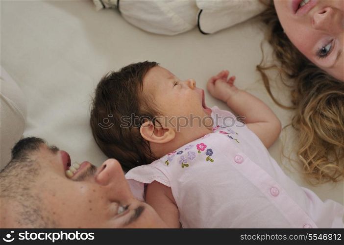 young family playing with cute little baby