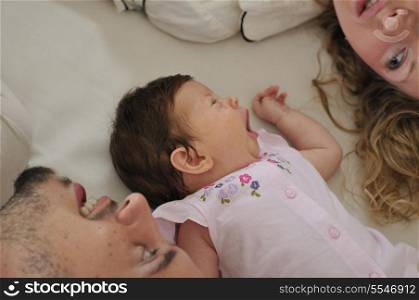 young family playing with cute little baby