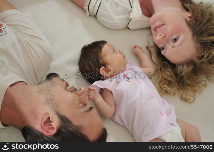 young family playing with cute little baby