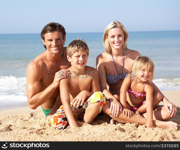 Young family pose on beach