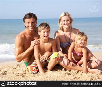 Young family pose on beach