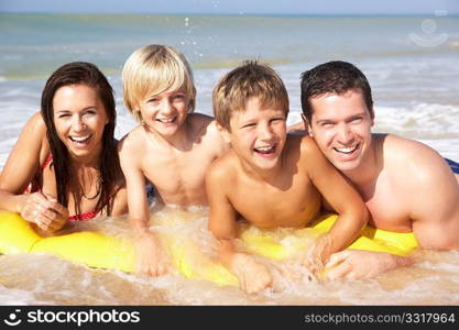 Young family pose on beach