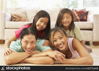 Young Family Relaxing At Home