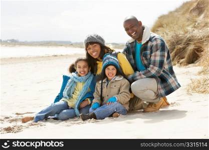 Young Family Relaxing On Beach Camping Holiday