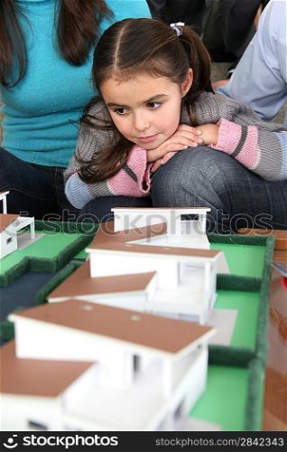 Young family sat with scale model of new home