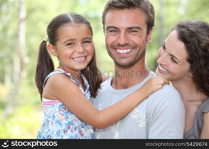 Young family stood in garden
