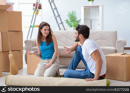 Young family unpacking at new house with boxes