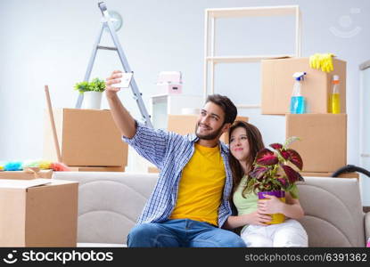 Young family unpacking at new house with boxes