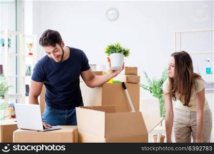 Young family unpacking at new house with boxes