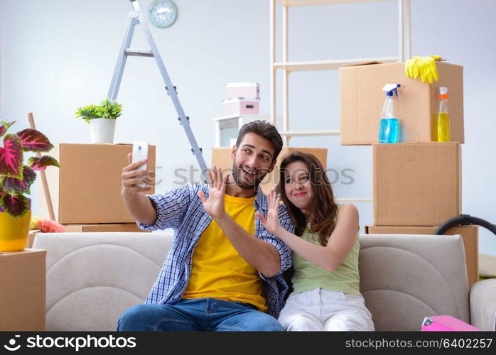 Young family unpacking at new house with boxes