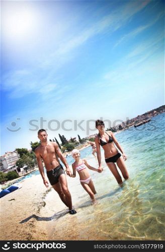 Young family walking by the ocean