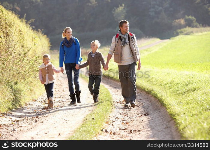 Young family walking in park