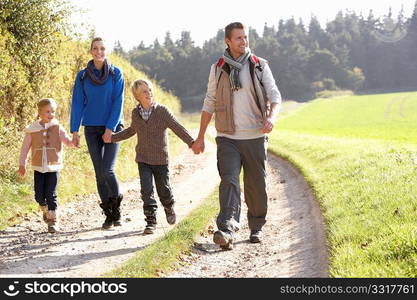 Young family walking in park