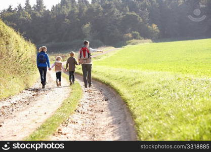 Young family walking in park