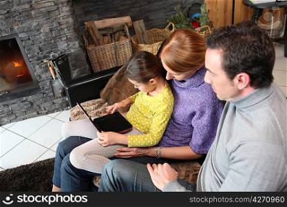 Young family watching film on laptop