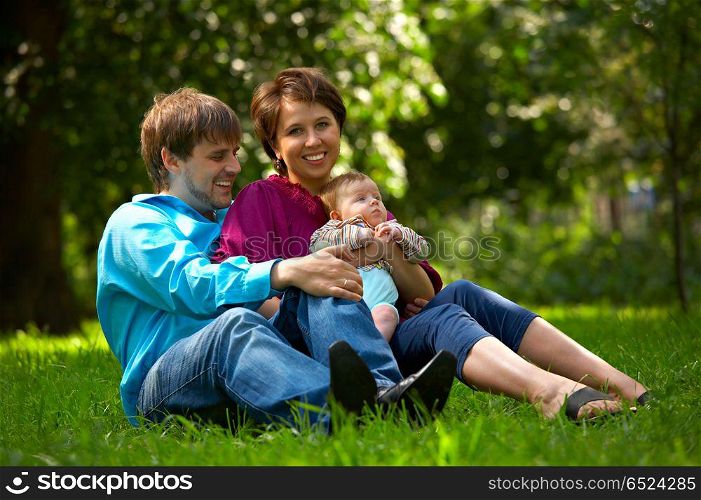Young family with child in the park. Happy family