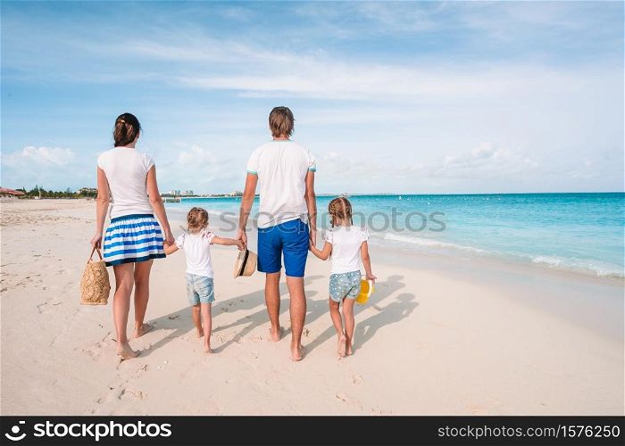 Young family with children on the beach. Photo of happy family having fun on the beach. Summer Lifestyle