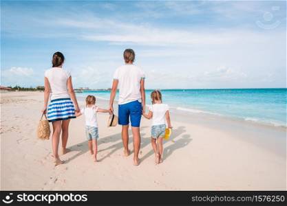 Young family with children on the beach. Photo of happy family having fun on the beach. Summer Lifestyle