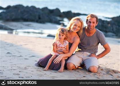Young family with daughter on beach