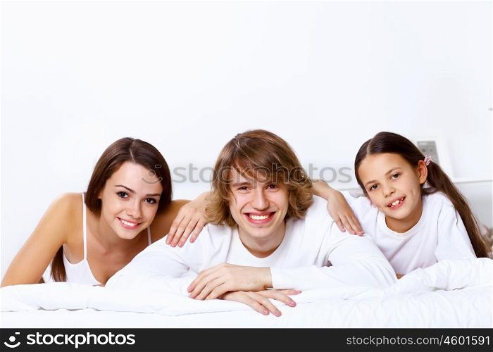 Young family with little daughter at home together