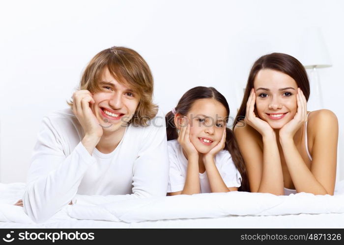 Young family with little daughter at home together