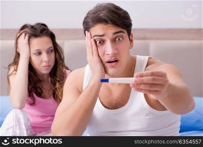 Young family with pregnancy test results