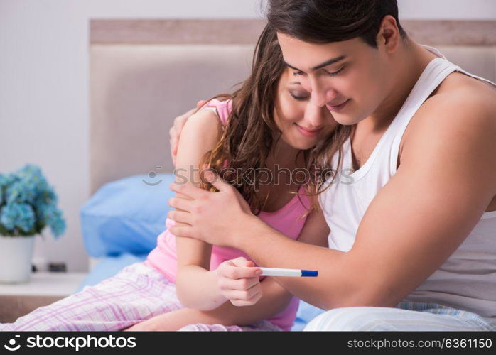 Young family with pregnancy test results