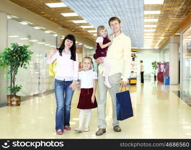 Young family with shopping bags doing shopping