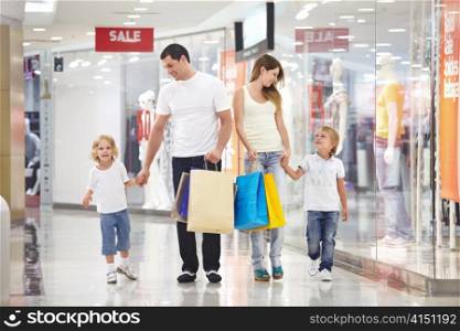 Young family with two children walking to the shops