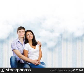 Young family. Young couple hugging each other and dreaming about future