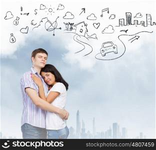 Young family. Young couple hugging each other and dreaming about future