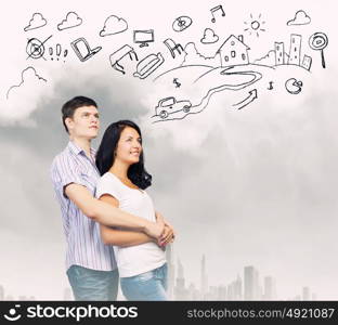 Young family. Young couple hugging each other and dreaming about future